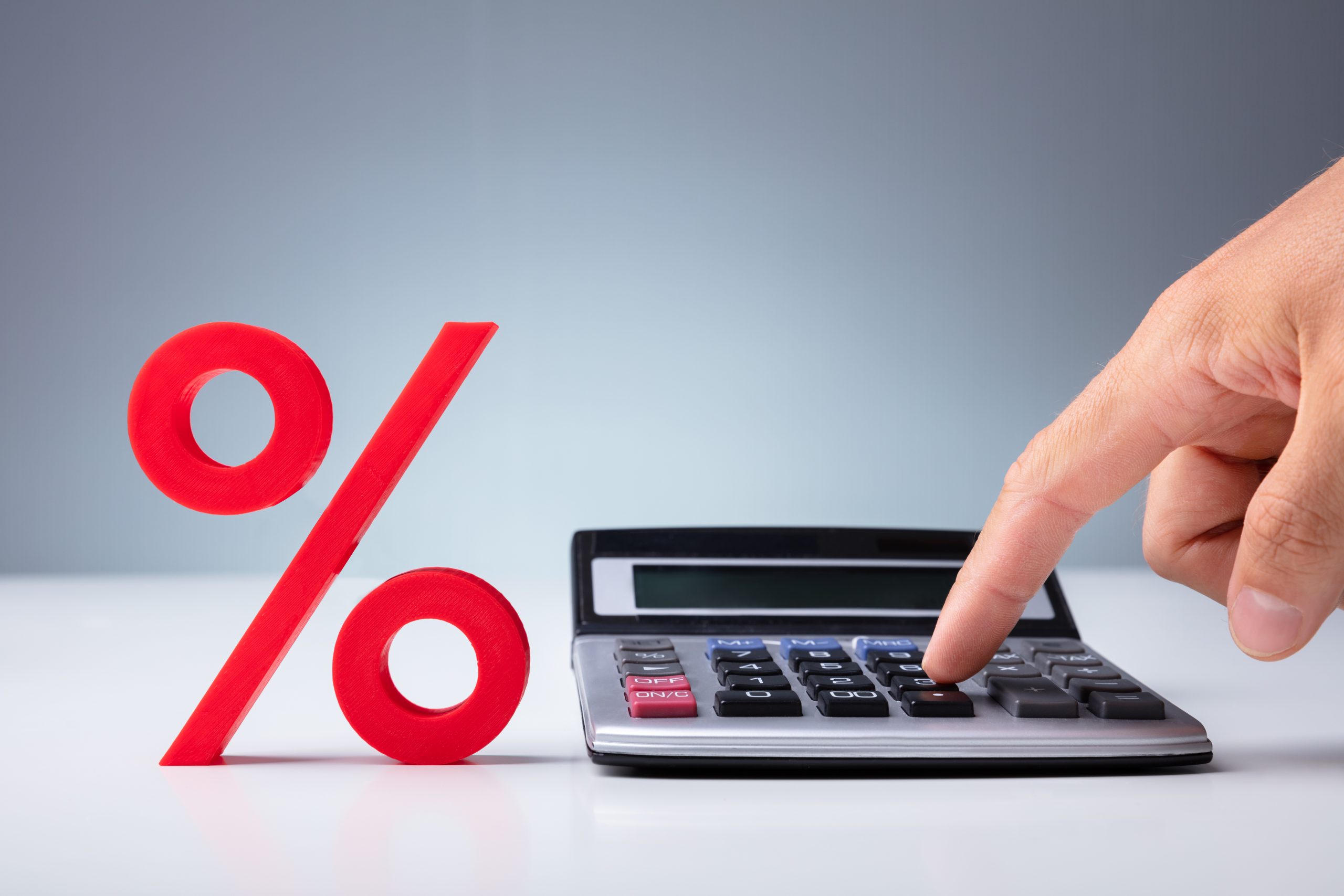 Percent Sign with Finger Pointing at Calculator from Shutter Stock