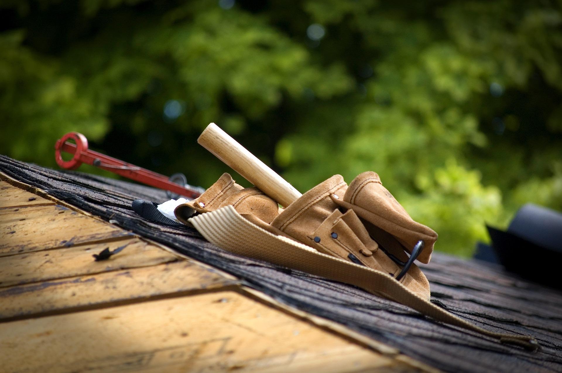 Group of hand tools on top of a roof being repaired
