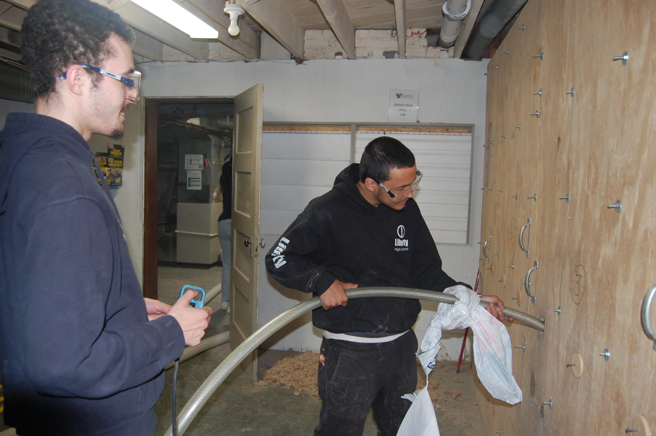 DSC_0031 two young men insulating a wall
