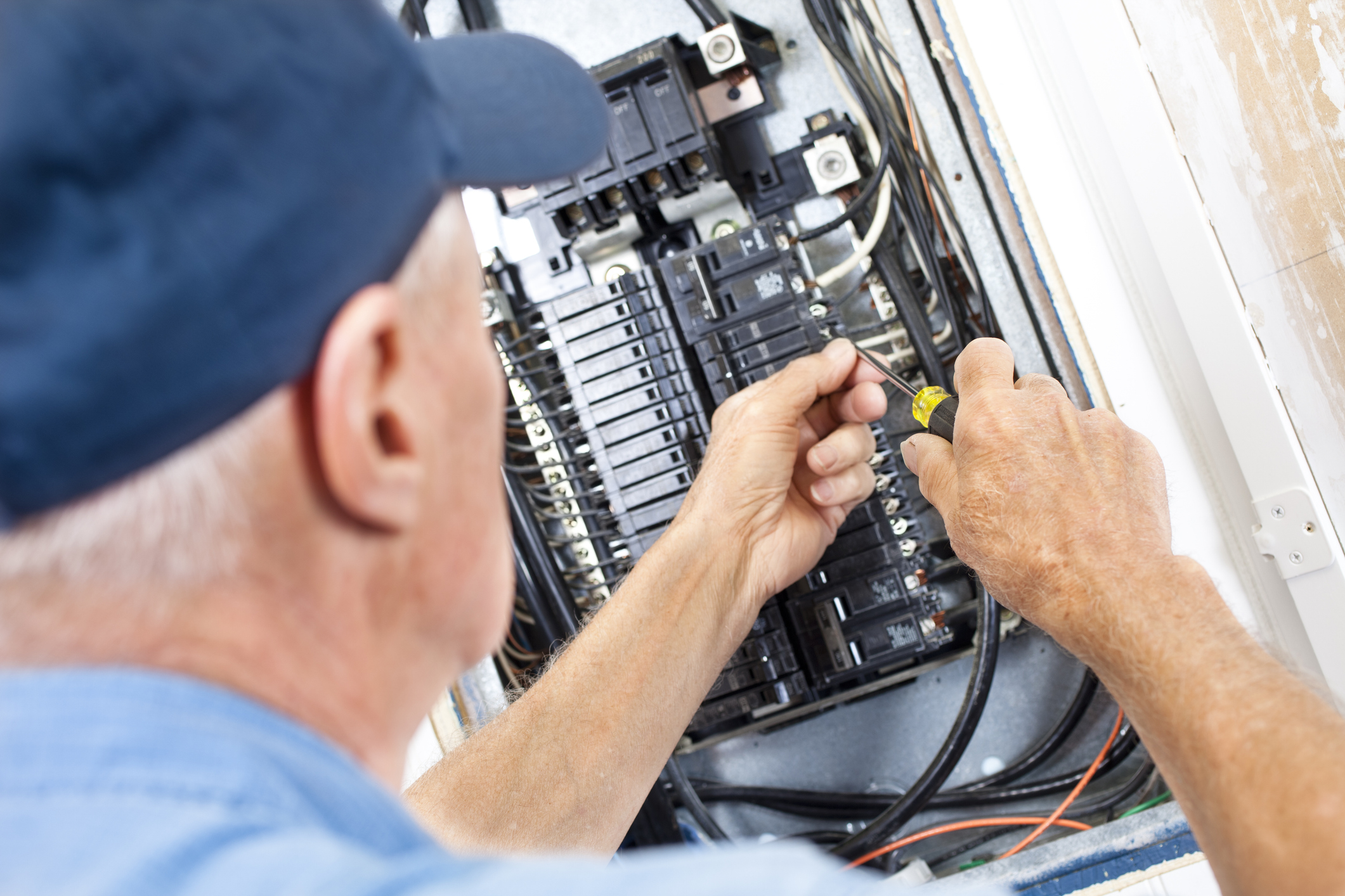 Electrician doing electrical work in breaker box electrician working on panel