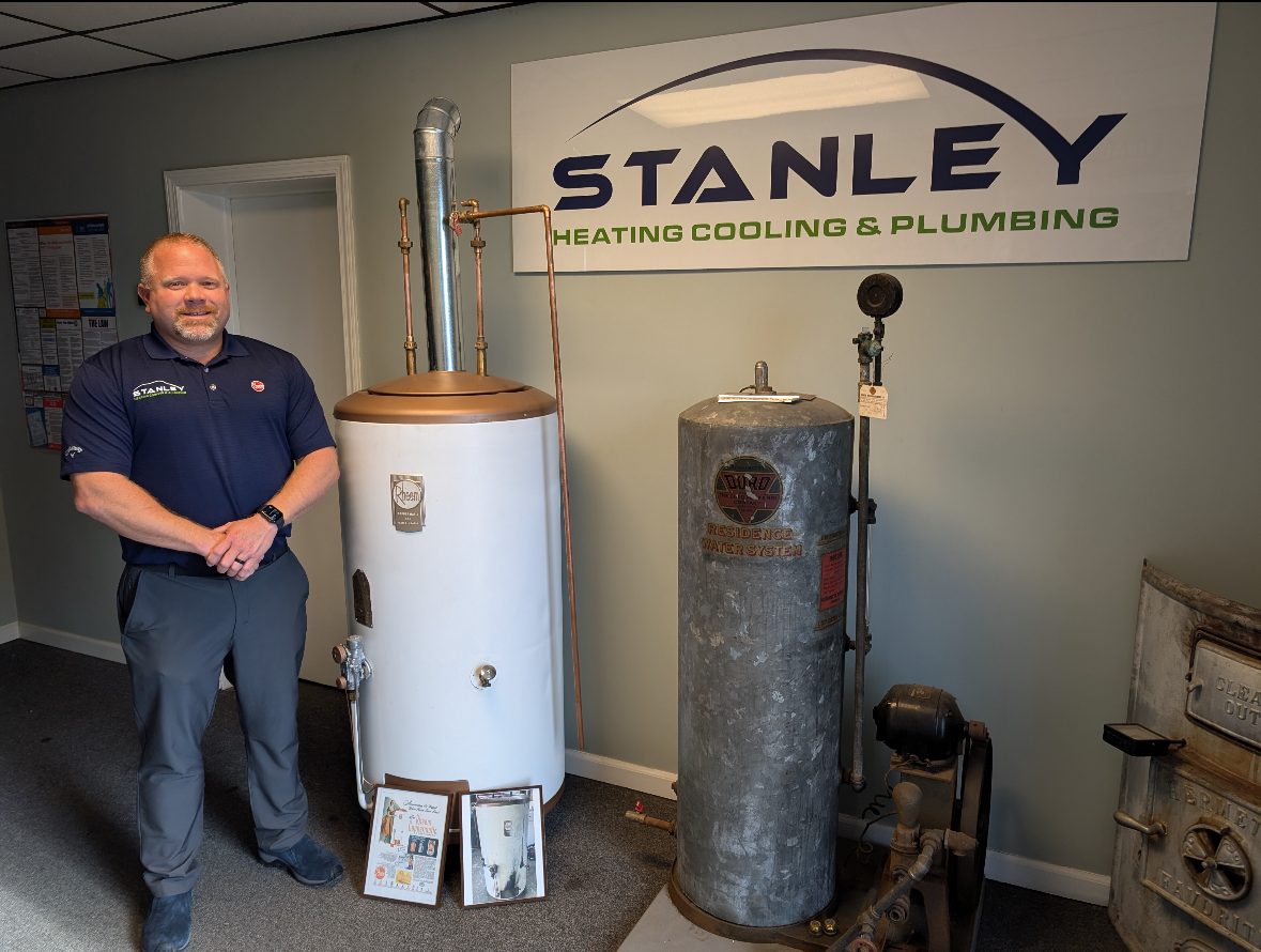 Jason Stanley Man standing with water heaters
