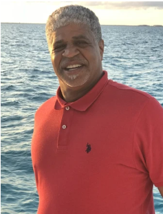 Black man in front of ocean