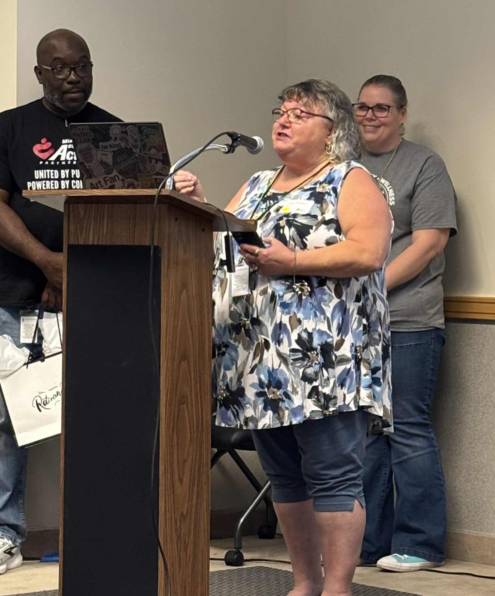 Sherrie Mauro speaking to coworkers