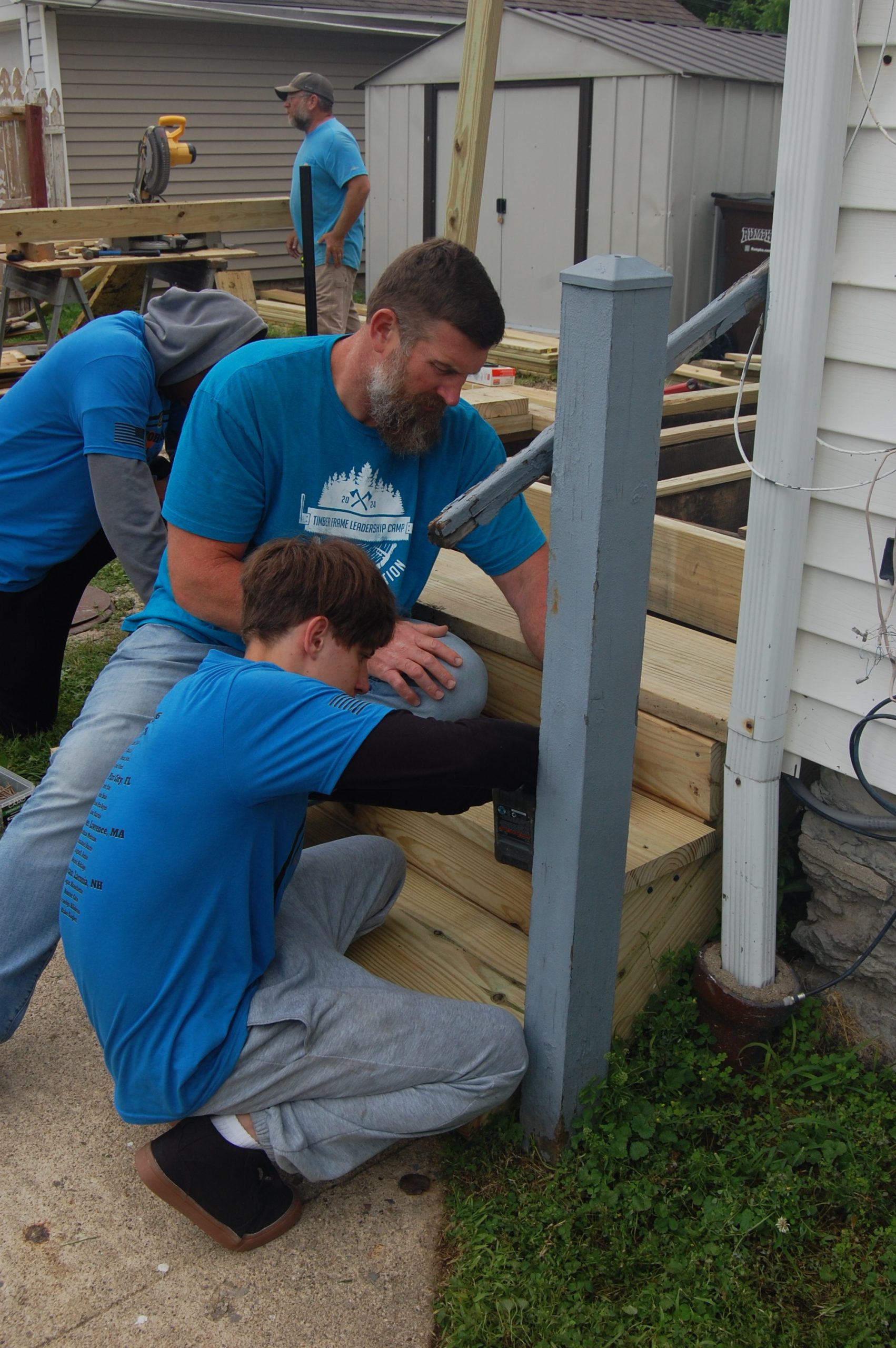 NFL Star Matt Light worked to rebuild the porch on MVCAP's emergency shelter in Greenville with the help of campers from his program for young men.